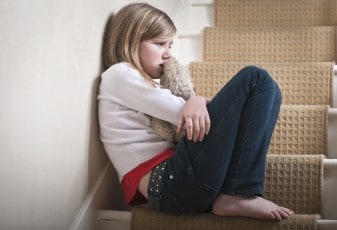 sad child sitting on stairs