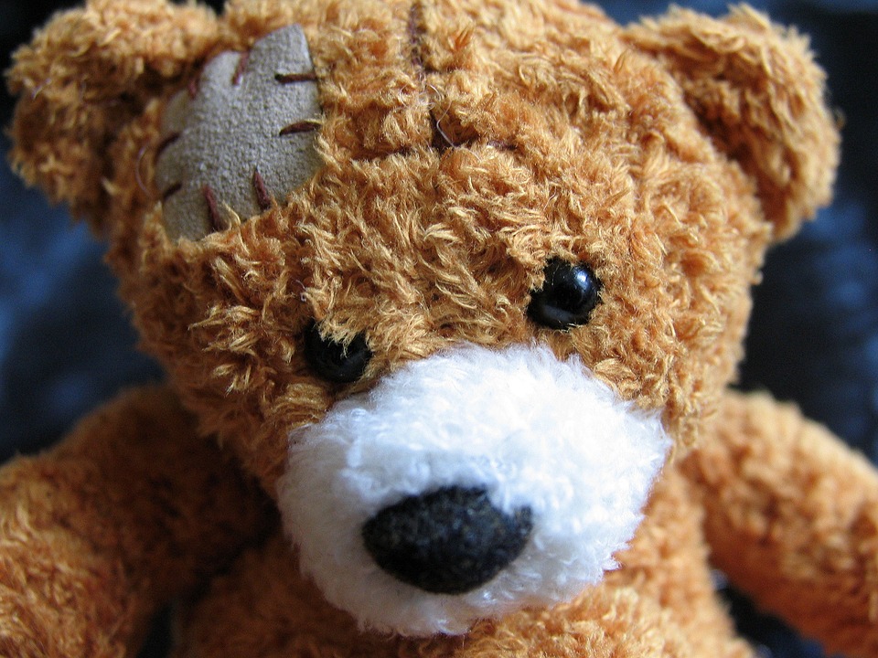 brown teddy bear with patch on head